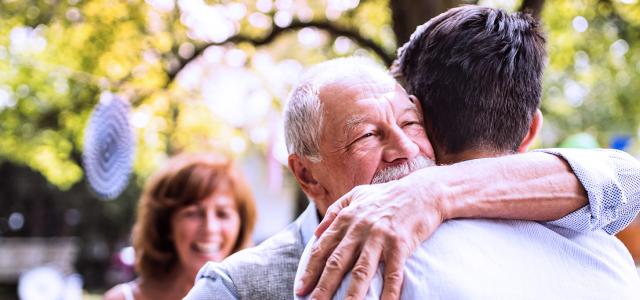 Man hugging his elderly father